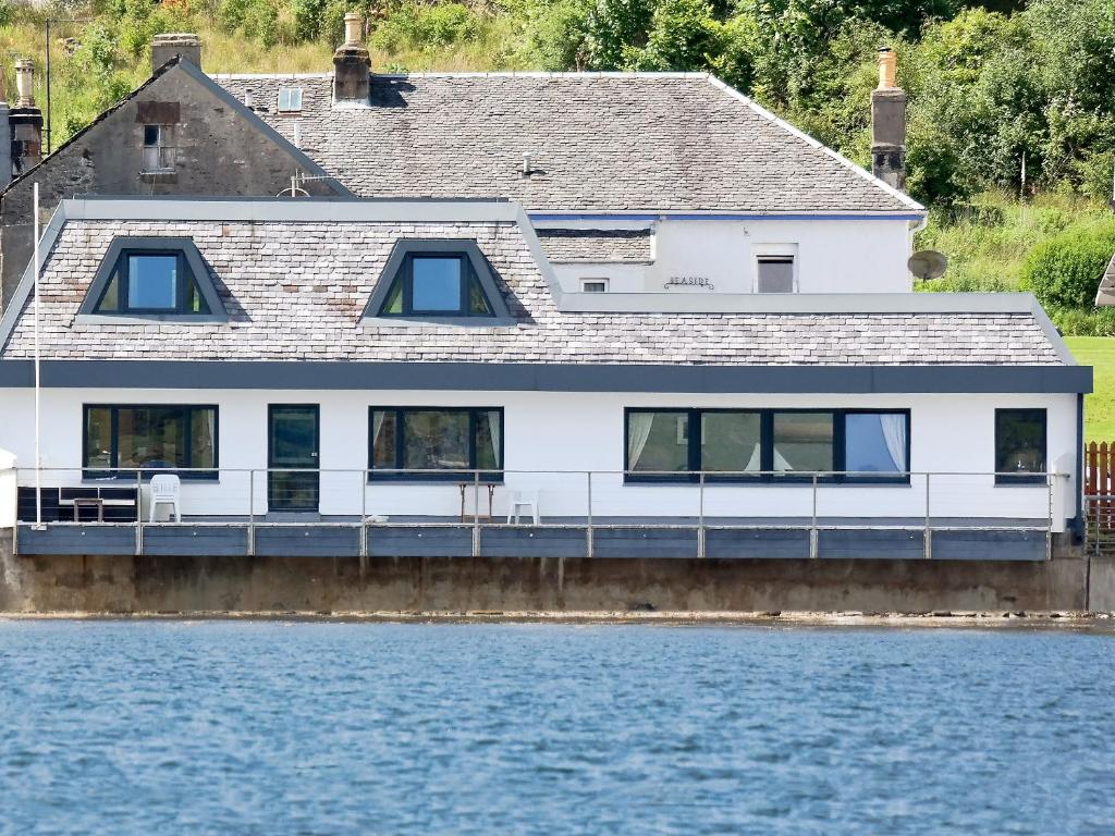 a house on a dock on the water at Waterside in Tighnabruaich