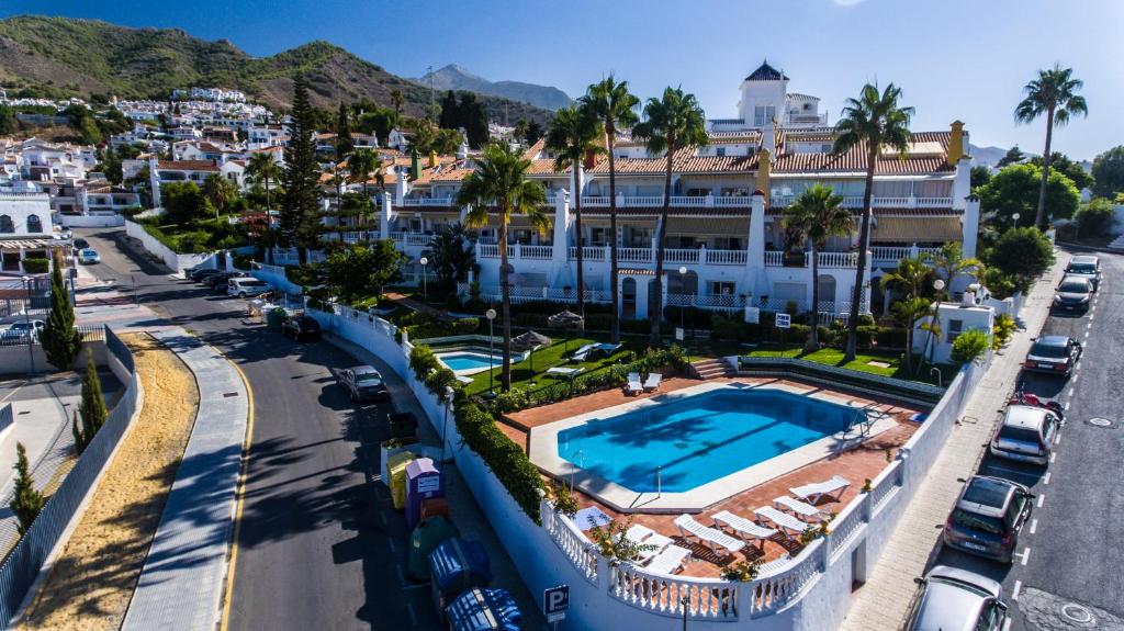 an aerial view of a resort with a swimming pool at Apartamentos Las Rosas de Capistrano in Nerja