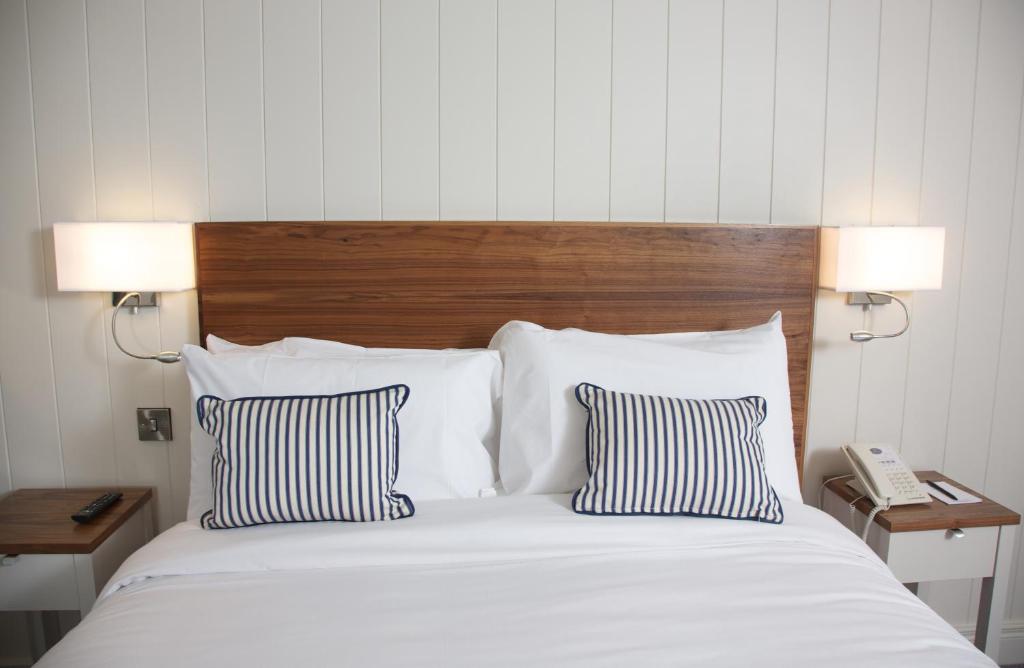 a bedroom with a bed with two pillows and a phone at Waterfront Hotel Dungloe in Dungloe
