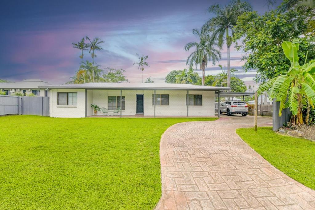 a white house with a green yard at Hidden Gem - 3BR Home - Cairns in Edge Hill