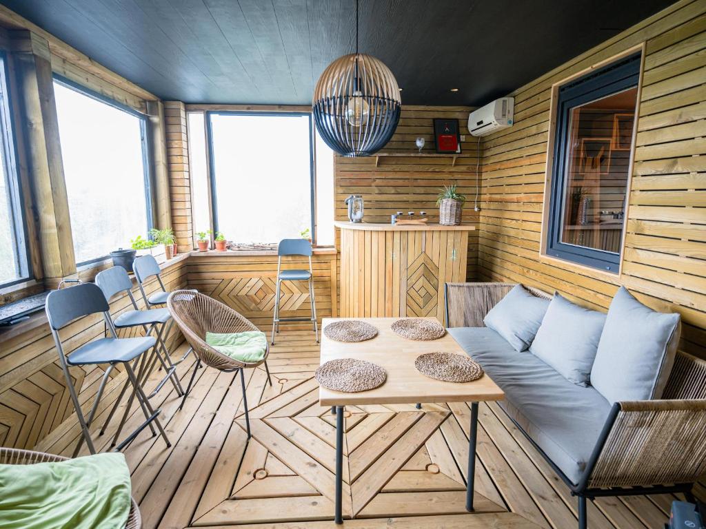 a living room with a couch and chairs and a table at Appartement Spa VIP du Pont Alsort 2-3 in Froid-Chapelle