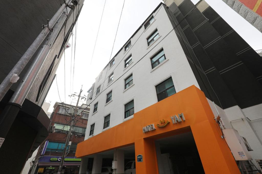 an orange entrance to a building in a city at Hotel Yam Bucheon Station in Bucheon