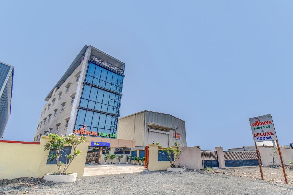 a large building with a sign in front of it at FabHotel Ayodhya in Pune
