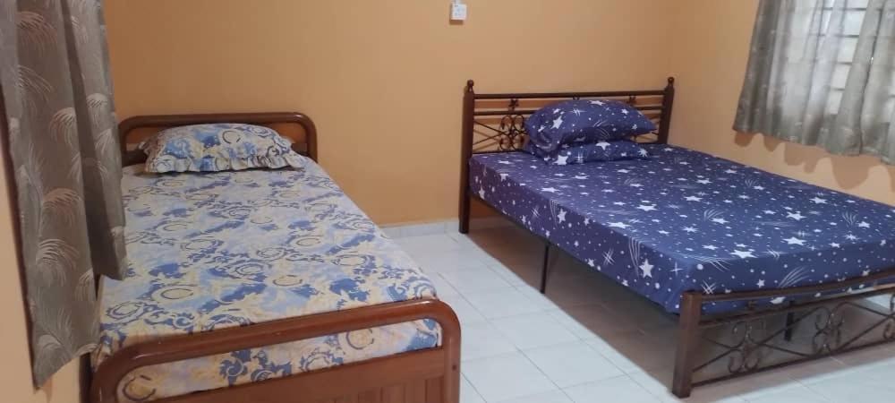 a bedroom with two beds in a room at Bayu Beach Chalet PCB in Kota Bharu