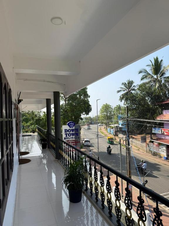 a balcony of a building with a view of a street at DOWN TOWN HOLIDAYS Kovalam in Kovalam