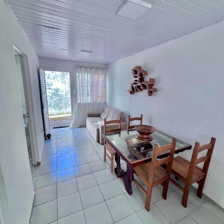 a living room with a table and chairs and a couch at Casa Barreirinhas in Barreirinhas