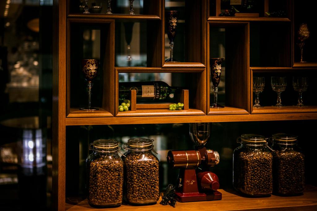 a shelf with five glass jars on it at Sotetsu Fresa Inn Ginza-Nanachome in Tokyo