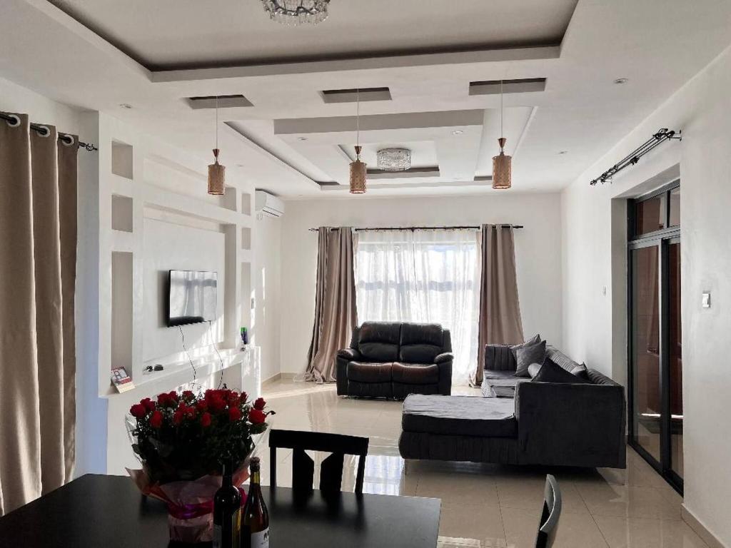 a living room with a couch and a table at Villa with 4 bedrooms in Lusaka