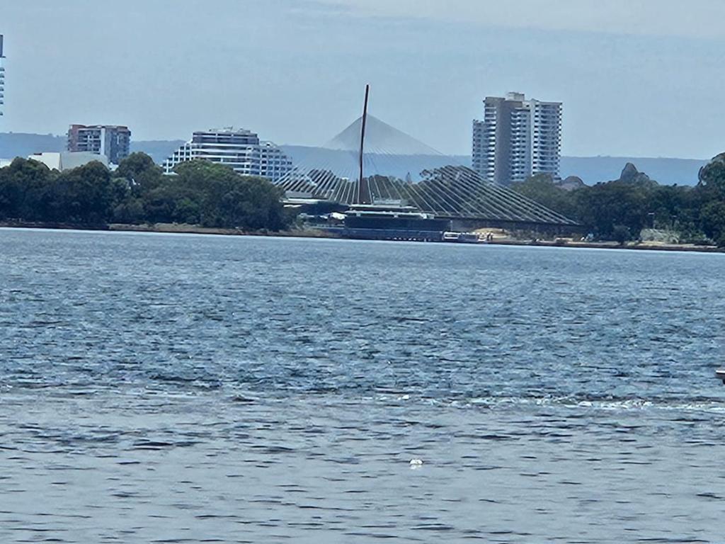 a large body of water with buildings in the background at Avocet Apartment in Perth