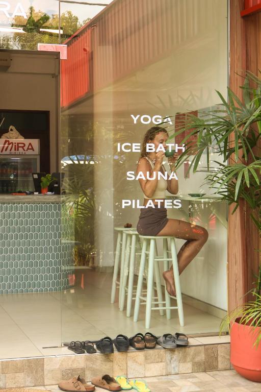 a store window with a woman sitting on a stool at Mira Mirissa in Mirissa