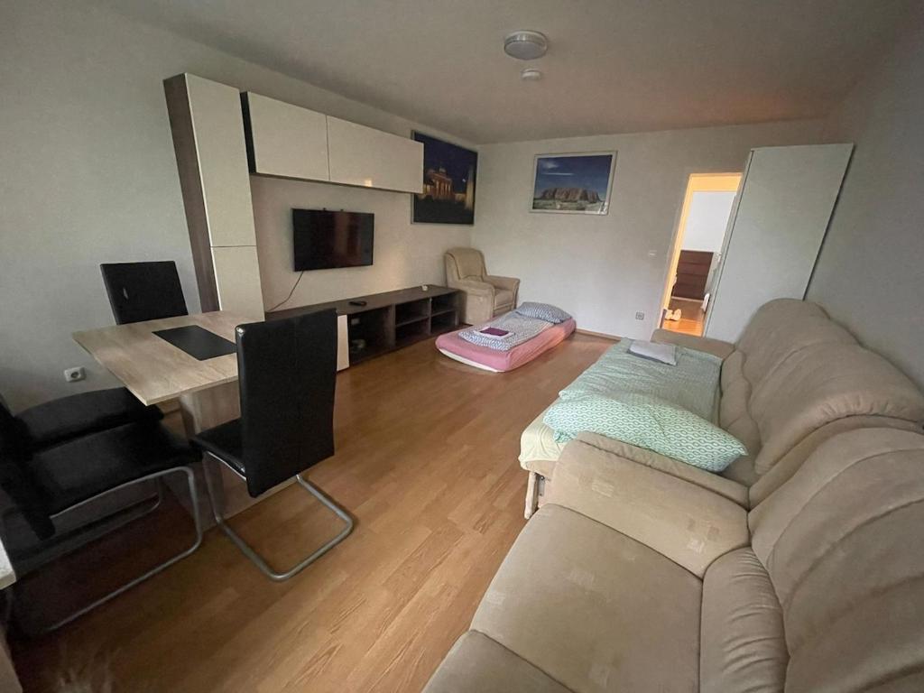 a living room with a couch and a table at Cosy Accommodation - very central in Munich