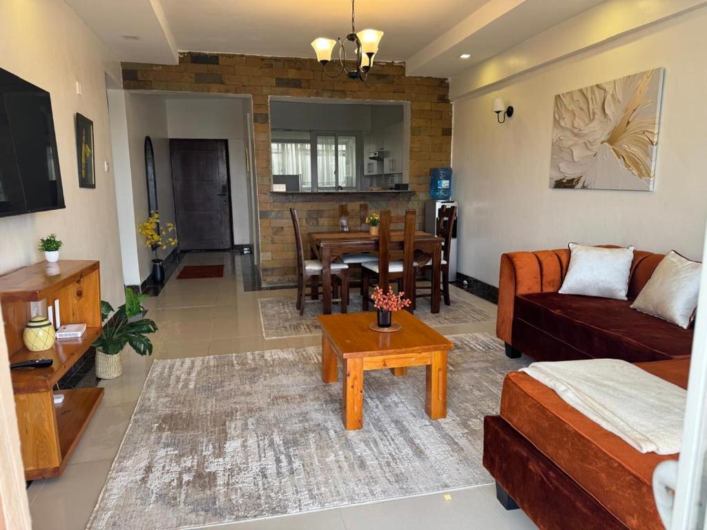a living room with a couch and a table at LJ Homes in Nairobi