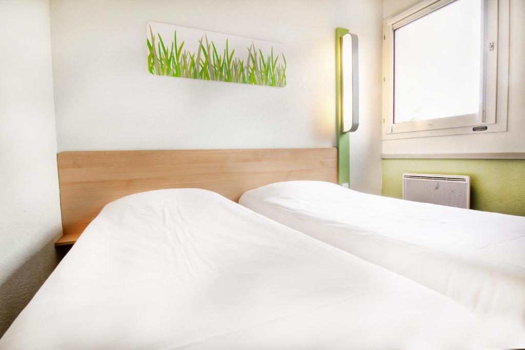 Postel nebo postele na pokoji v ubytování ibis budget Besançon Ecole Valentin