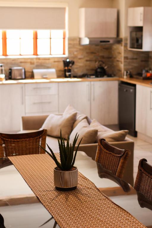a kitchen with a table with a plant on it at The Gables-Clarens in Clarens