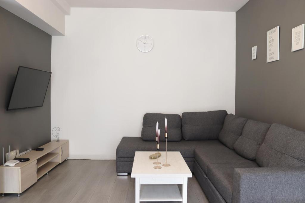 a living room with a couch and a table at Domel Yerevan Moskovyan 28 in Yerevan