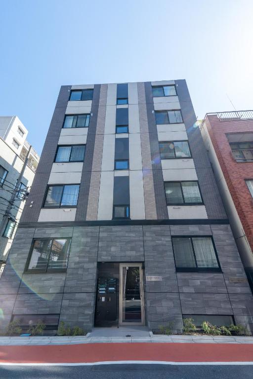 a tall building with a door in the middle at 新築Sunbright Asakusa 101 in Tokyo