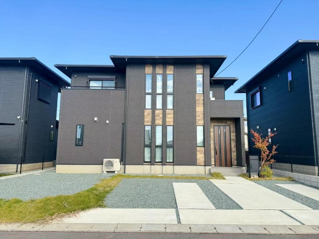 a large brick building with a driveway in front of it at Akikawa Waifu 2 プレミアム木造 一棟貸切ヴィラ in Kikuchi