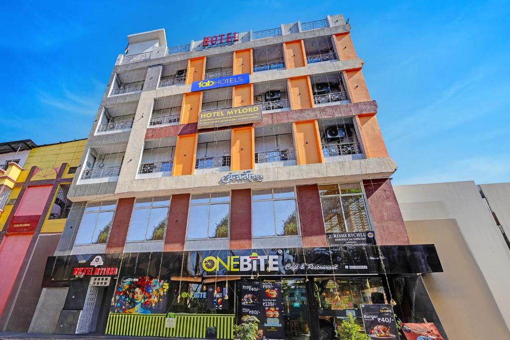 a tall building with orange doors and windows at Via Lords inn in Bhopal
