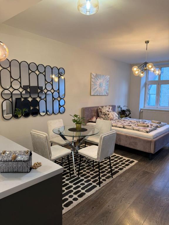 a room with a bed and a table and chairs at All you need is Love1 in Bratislava