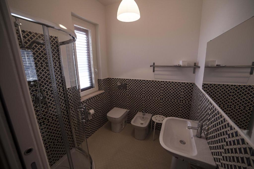 a bathroom with a toilet and a sink and a shower at Home Scala dei Turchi B&B in Realmonte