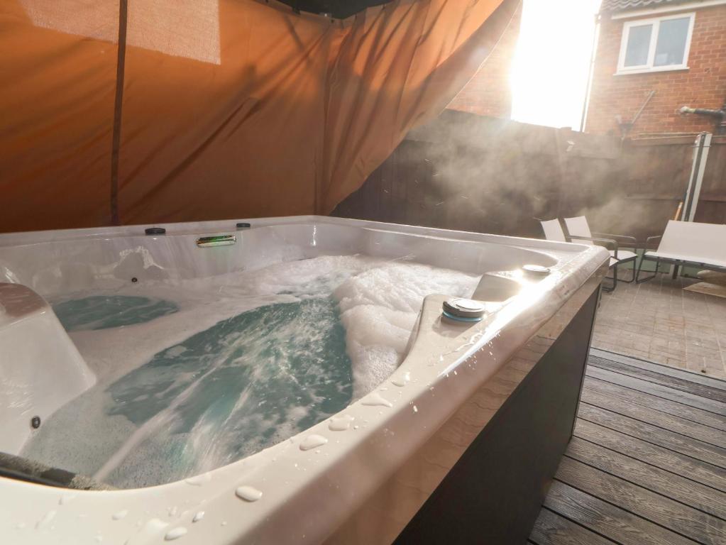 a jacuzzi tub with steam coming out of it at Steam and Stay Hoole in Chester