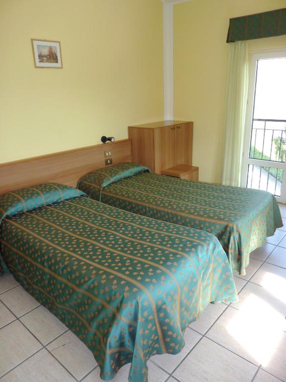 Postel nebo postele na pokoji v ubytování Hotel Del Fiume