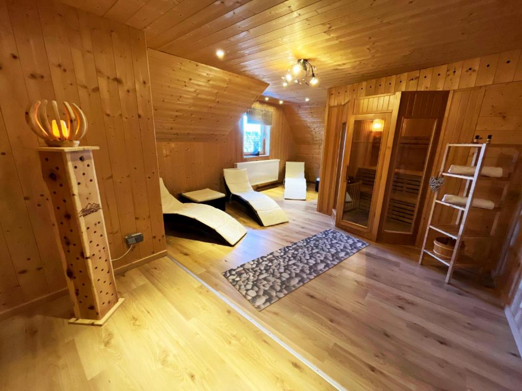 a room with two beds in a wooden room at Almhütte Grosserhütte in Katschwald