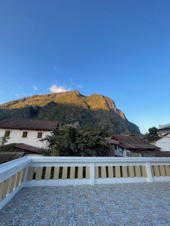a white fence with a mountain in the background at Nongkhiaw Chansai Guesthouse in Nongkhiaw