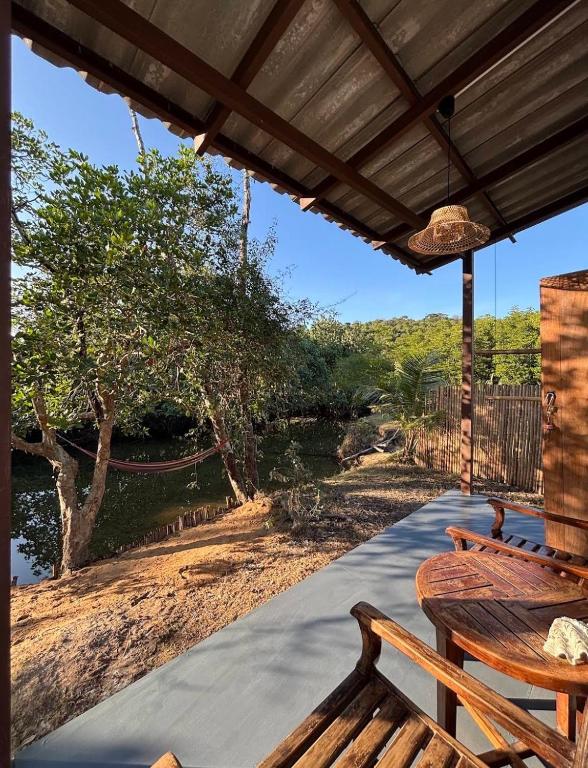 a porch with benches and a view of a river at Baan Rim Len Koh Kood in Ko Kood