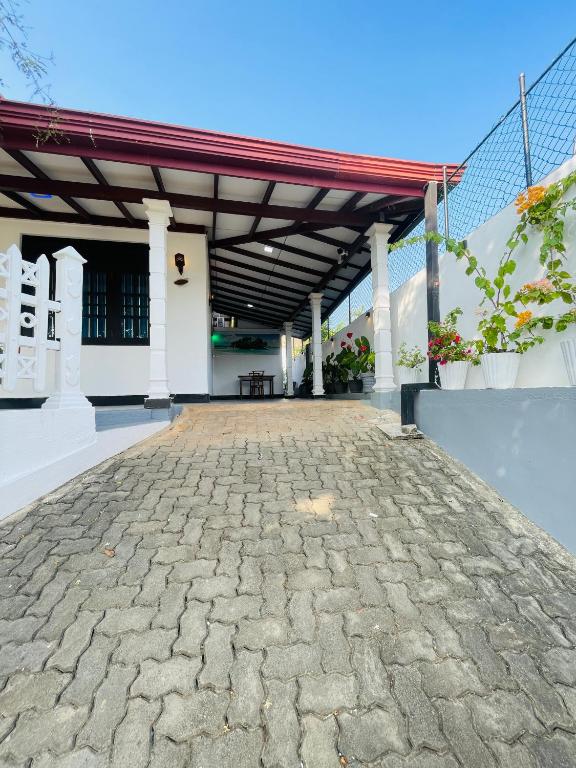 a large pavilion with a stone patio at Sasanda Villa in Weligama