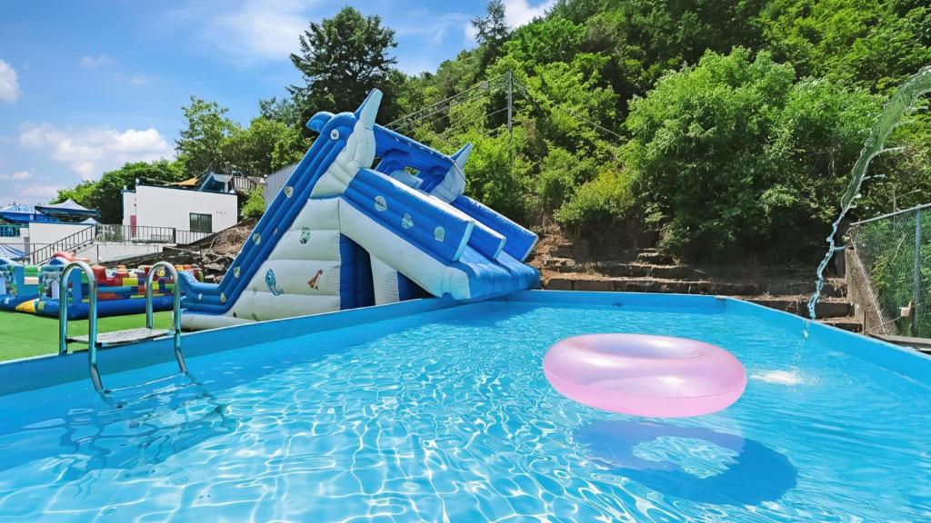 a water slide in a pool at a water park at Chuncheon Dogandstay in Chuncheon