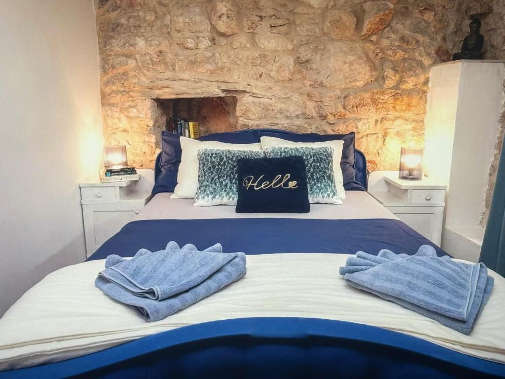 a bedroom with a bed with blue towels on it at Molo selo area in Stari Grad