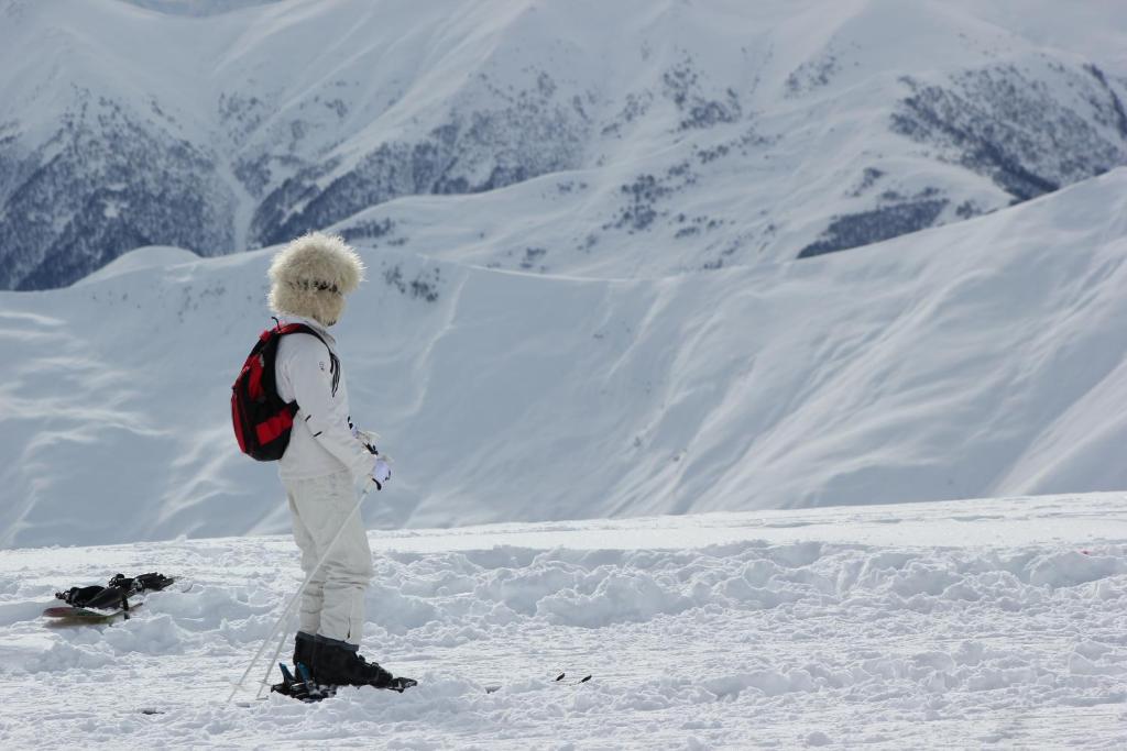 a person standing on top of a snow covered mountain at Apartments in New Gudauri in Gudauri