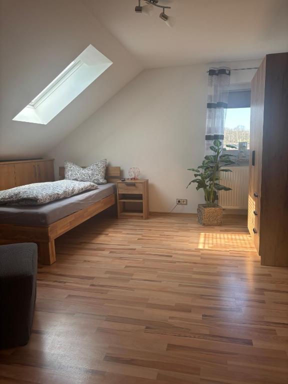 a bedroom with a bed and a skylight at Ferienwohnung Schaller in Berg