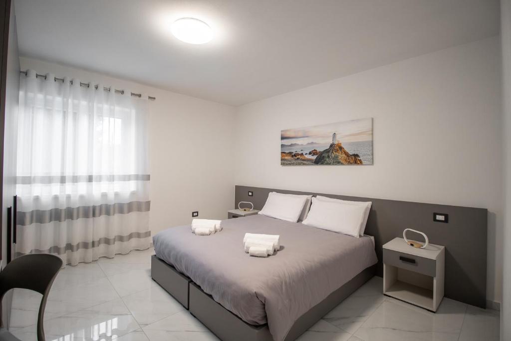 a bedroom with a bed with two pillows on it at Alessia Living in San Michele allʼAdige