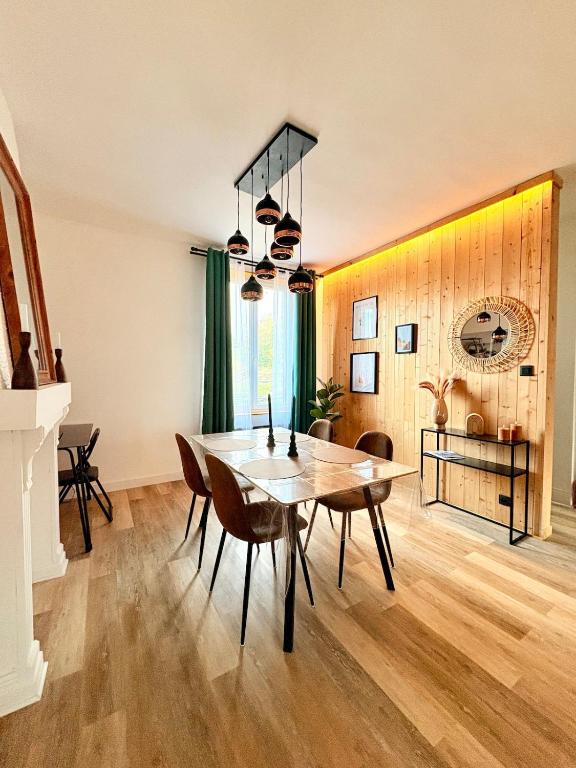 a dining room with a table and chairs at Bright loft-style duplex 6 people Dunkirk in Coudekerque-Branche