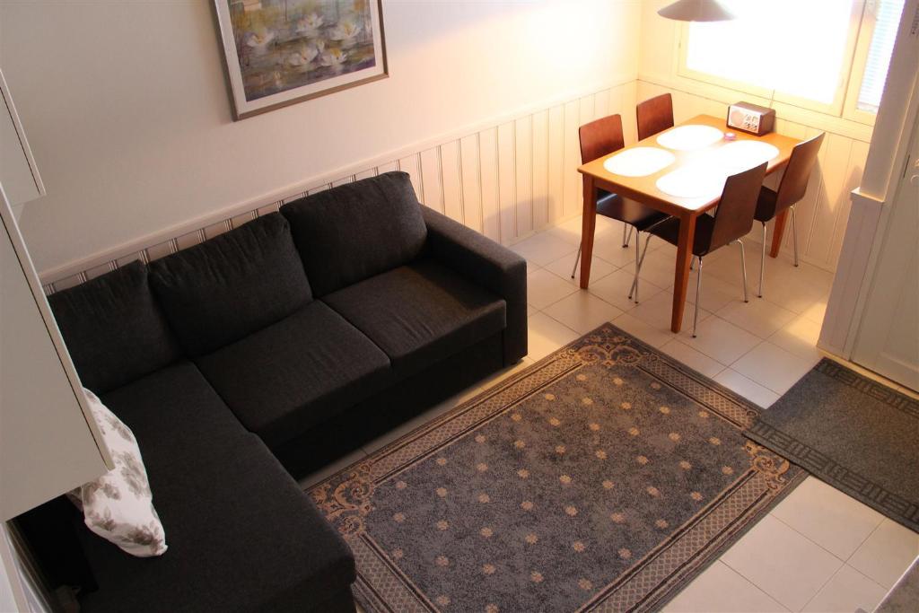 a living room with a black couch and a table at Moonlight 213 Visit Levi in Levi