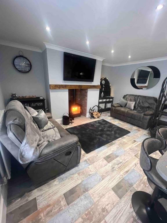 a living room with a couch and a fireplace at Longshore Drift in Woodhorn