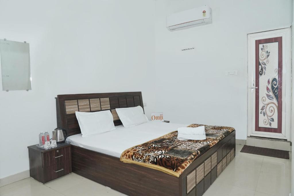 a bedroom with a large bed in a room at Omji Ashram Jageshwar Mahadev in Varanasi