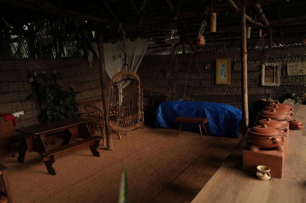 a room with a room with a table and chairs at Cosy Concepts in Kovalam