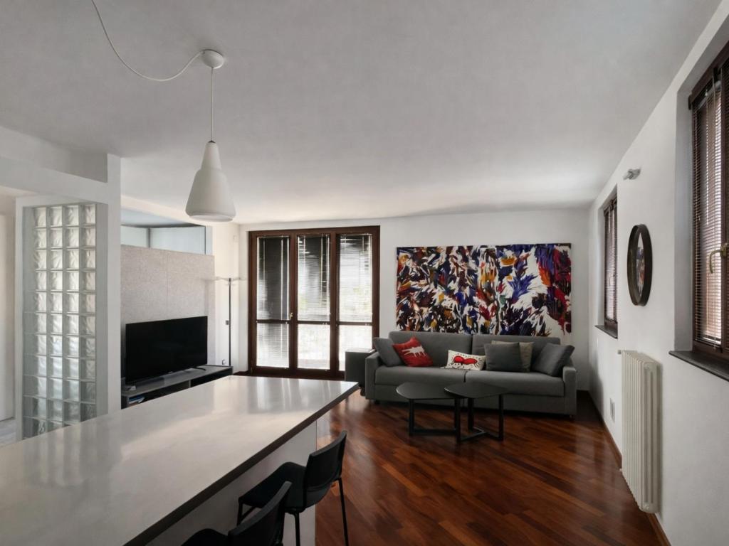 a living room with a couch and a table at BASTIA RF Suite up to 4 guests - in the heart of Scalo Romana, Olimpico, Prada, Bocconi and easy access Forum Assago, IEO, IED, Duomo, San Siro in Milan