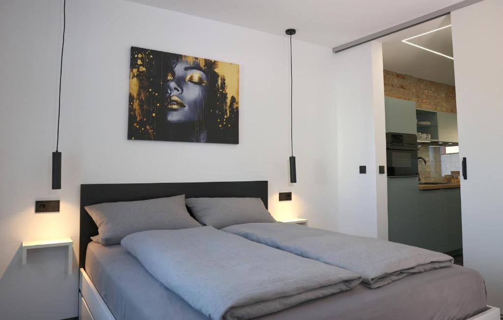 a bedroom with a bed with a painting on the wall at Ferienwohnung Petra in Ilmenau