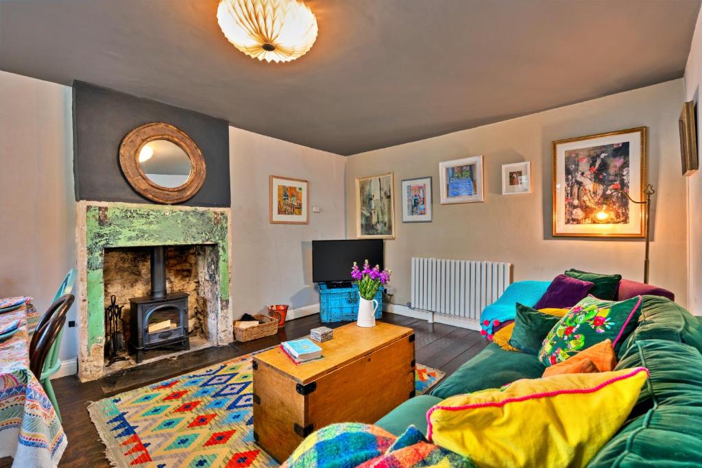 a living room with a couch and a fireplace at Finest Retreats - Flittermouse Cottage in Wingfield