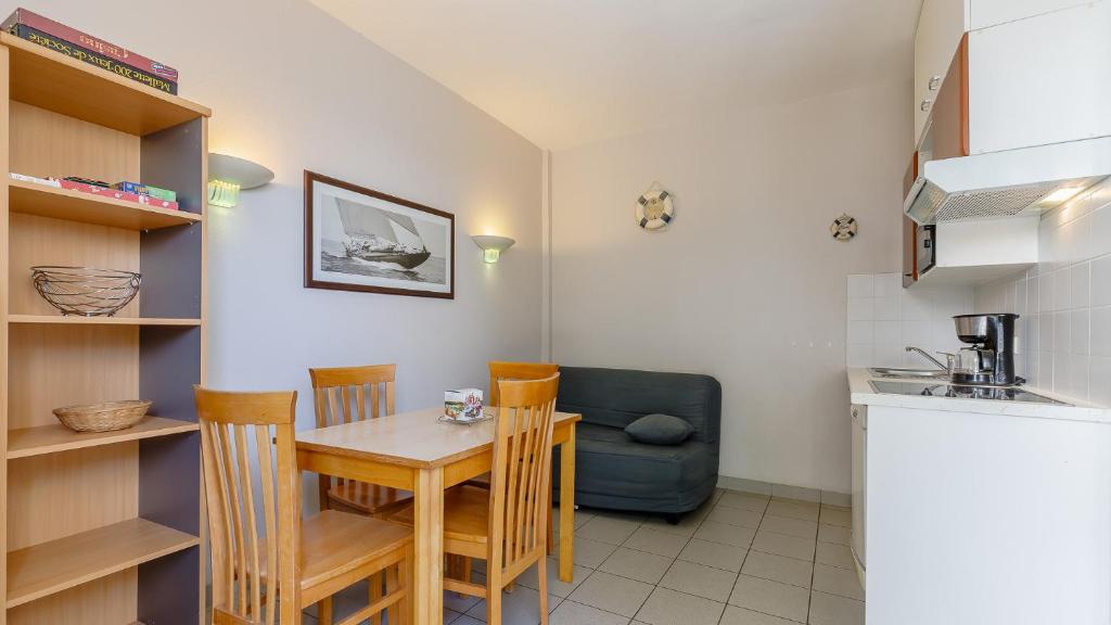 a kitchen and dining room with a table and chairs at L Ocean N11 2P4 in La Tranche-sur-Mer