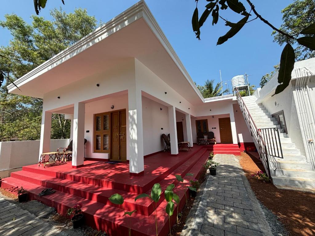 a rendering of a house with a red deck at Tranquil Waves Marari in Mararikulam