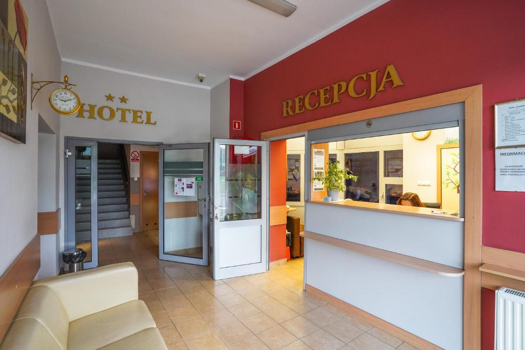 a restaurant with a hotel sign on the wall at Hotel Stadion in Kielce