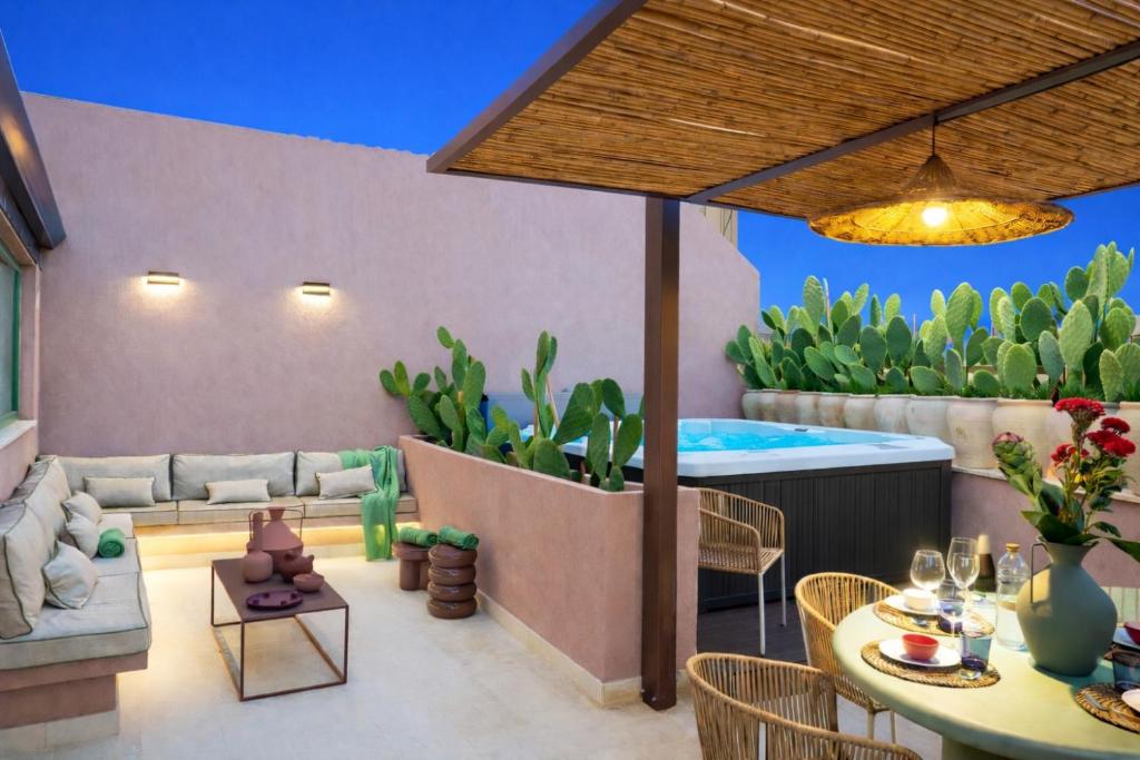 a living room with a couch and a table at Vico Trigona SicilyMyHome e jacuzzi riscaldata in Noto