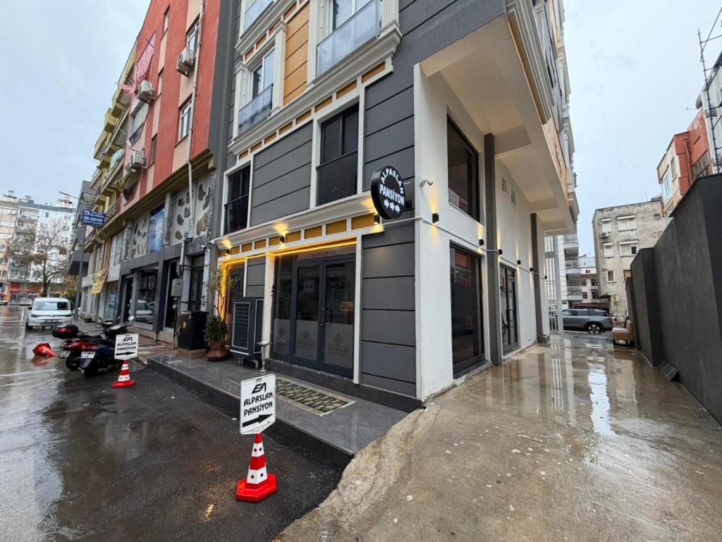 a building with street signs in front of it at Alpaslan Otel Pansiyon in Antalya