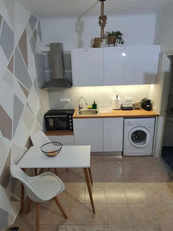 a small kitchen with a table and a sink at Galatia Studio in Thérissos