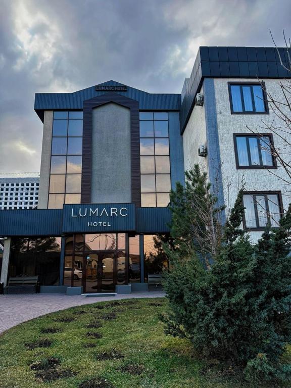 a building with a sign for a hotel at Lumarc Hotel in Bishkek